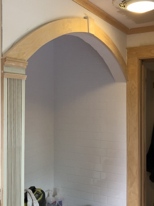 A custom bath surround to mimic historic Arched doorways throughout the house.